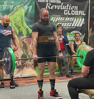 Group of fitness coaches training with weights in a gym setting