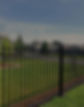 Black metal fence on a green lawn