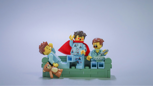 3 LEGO boys playing on a couch