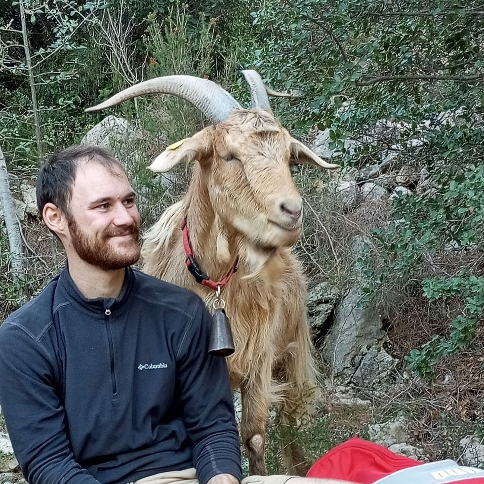 A comical image of a young man sitting next to a larger male goat.