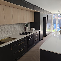 Post construction cleaning Sydney - modern kitchen with two-tone cabinets, white benchtops and hexagonal splashback cleaned to handover standard by Flawless Sydney Cleaning