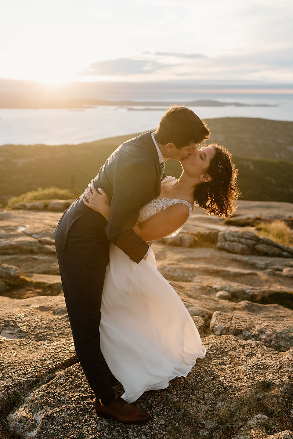 bride and groom having their wedding portraits on cadillac mountain 