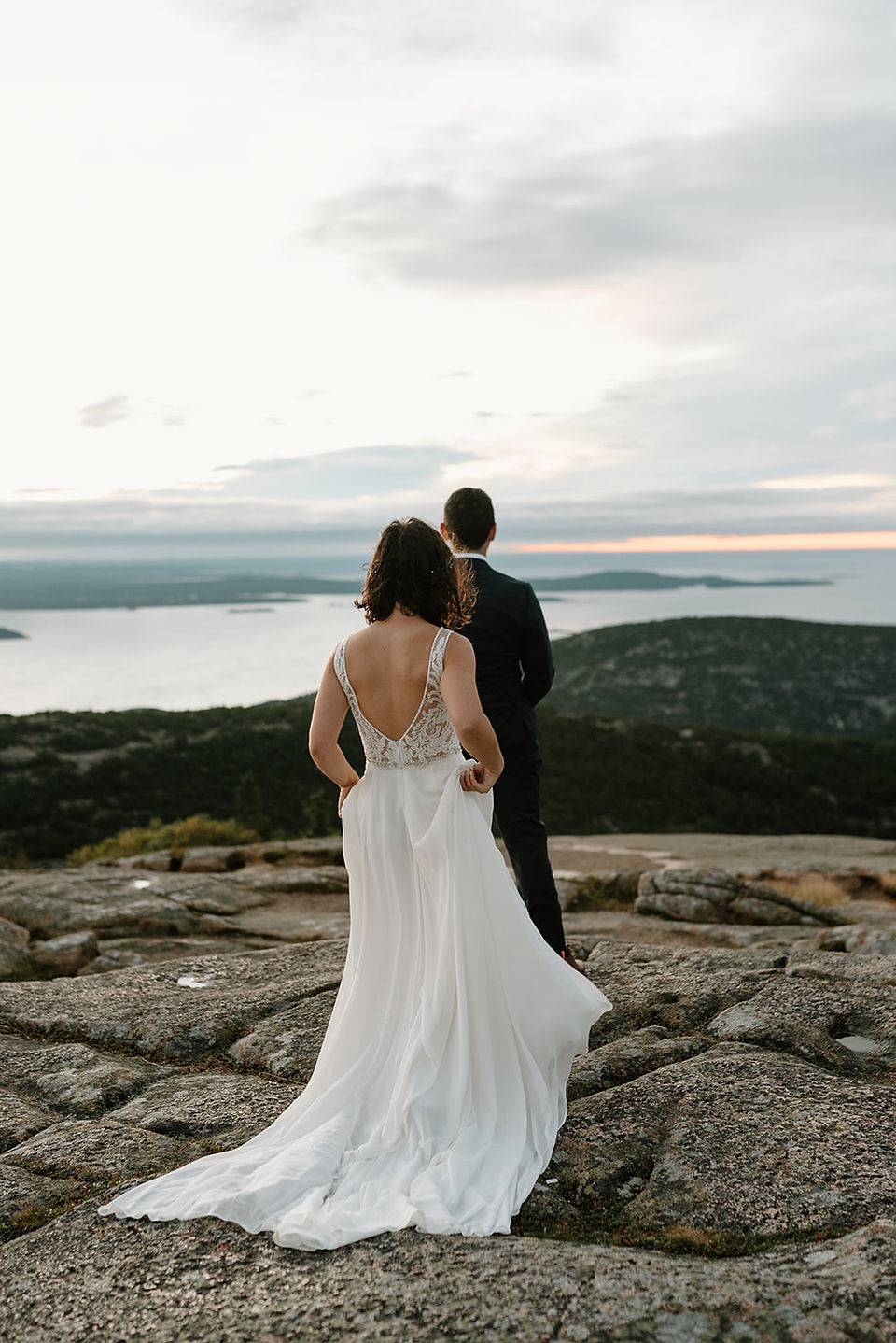 bride and groom having their wedding portraits on cadillac mountain 