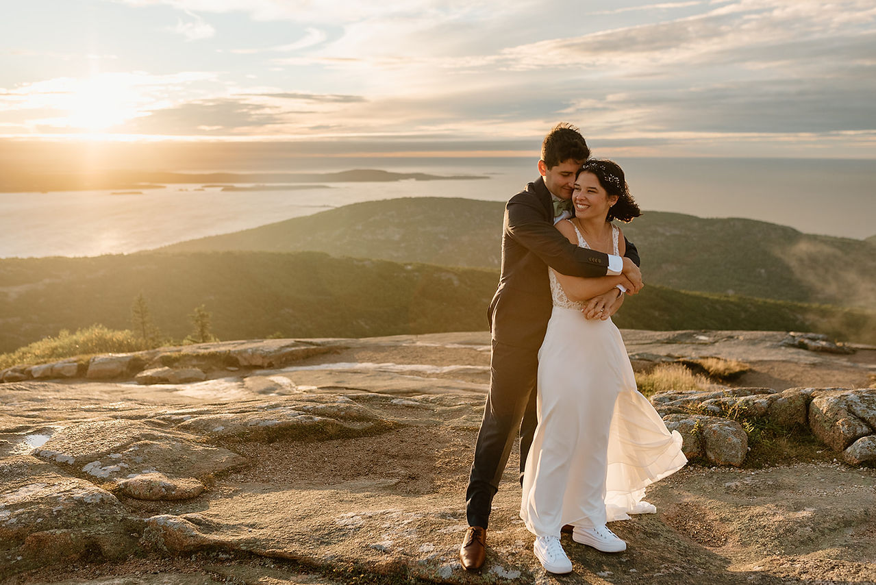 bride and groom having their wedding portraits on cadillac mountain 