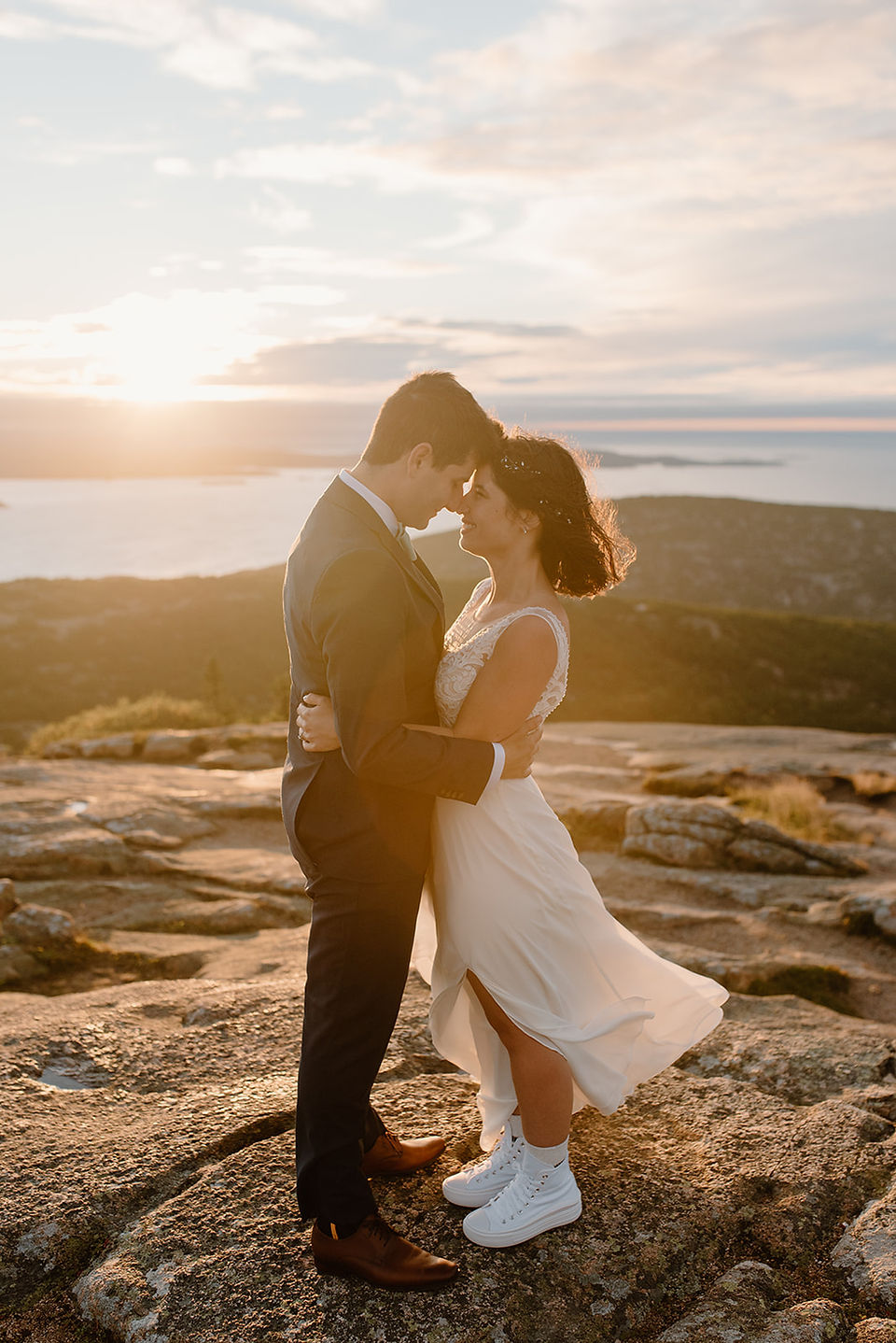 bride and groom having their wedding portraits on cadillac mountain 