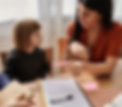 A child advocate sits with a family, offering child support services.