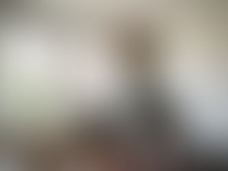 Expat woman changing light bulb in Uccle apartment