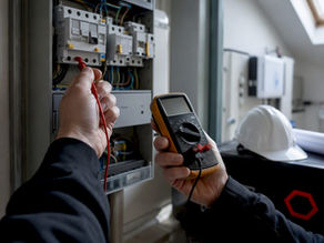 Inspector testing electrical panel grounding