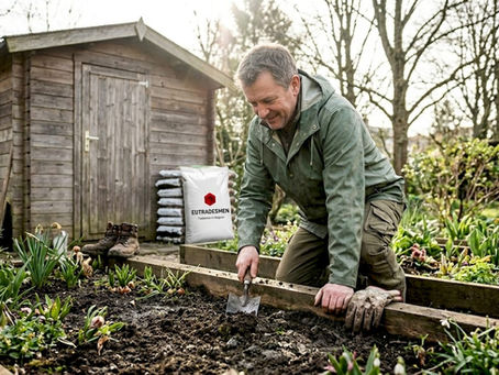Gardener loosening clay soil Brussels backyard
