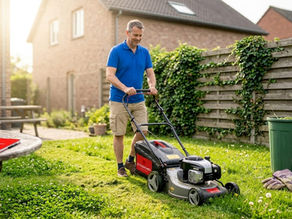 Expats mowing lawn in Waterloo backyard