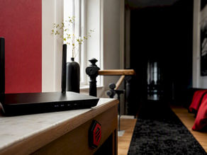 Anonymous router in shadowed Belgian home hallway