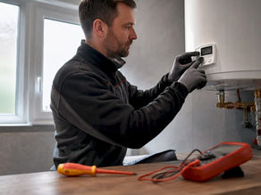 Technician hands testing electric water heater