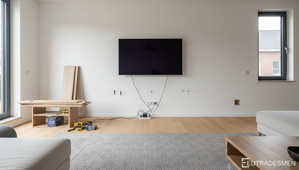 Flat screen television being installed on a wall in an expats home in Leuven