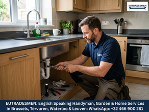 English speaking handyman fixes a plumbing issues under a sink in Leuven.
