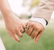Bride and groom linking pinkies in a romantic promise of forever, captured during an intimate wedding by Wistoria Events.