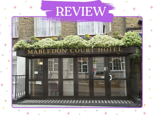 Hotel entrance with sign Mabledon Court Hotel, brick facade, flowered awning, glass doors, and checkerboard doorstep.