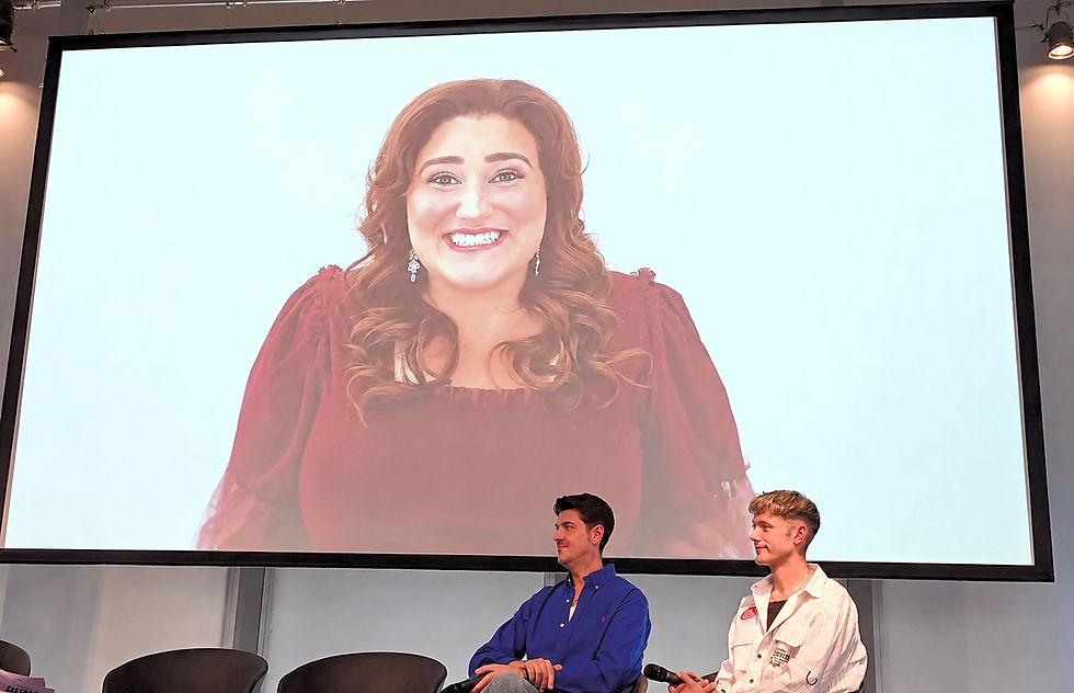 A special video message from Kaycee Stroh, who played Martha Cox in the original High School Musical films, is shown during the Disney High School Musical press launch at The Lowry as co-directors Joseph Houston and William Whelton look on.