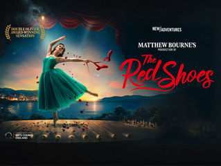 Ballet dancer in a green dress leaps onstage, holding red shoes with petals, backed by a sunset over water. Text: Double Olivier Award-Winning.