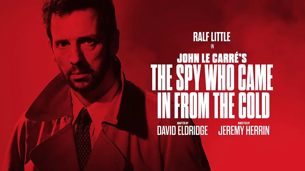 Red poster of serious man in trench coat for John le Carré’s The Spy Who Came In From the Cold, starring Ralf Little.