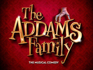 Golden text "The Addams Family: The Musical Comedy" on red patterned background. A disembodied hand rests on letters, creating a whimsical mood.