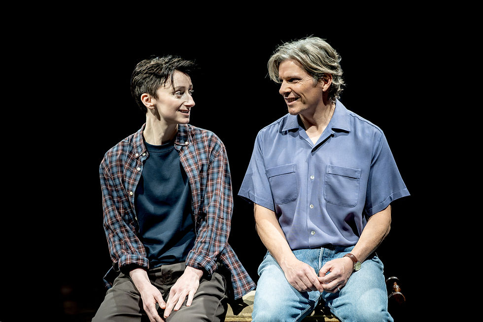 Adult Alison shares a quiet moment with her father Bruce during Fun Home at the Royal Exchange Theatre, Manchester.
