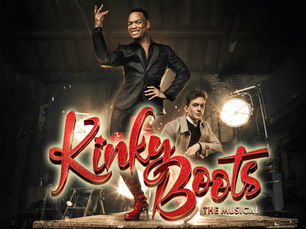 Red thigh-high boots stand beside bright lights with "Kinky Boots The Musical" text. Industrial background, energetic mood.