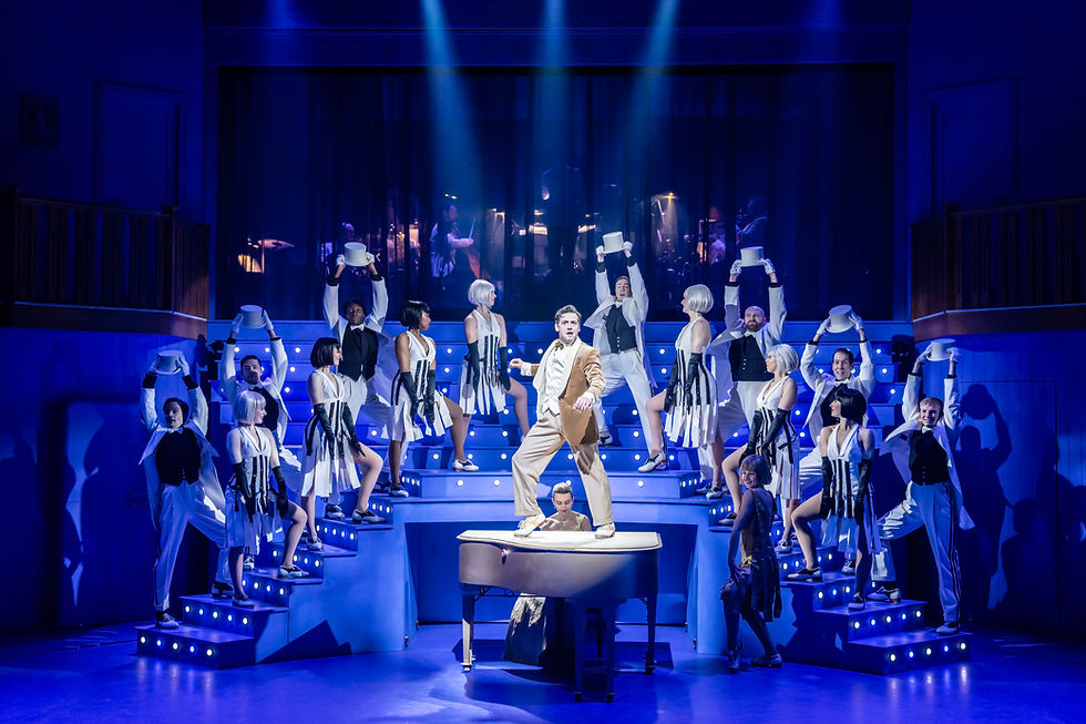 Stuart Neal (Phil) and members of the Company in Irving Berlin’s White Christmas. Photo by Johan Persson.