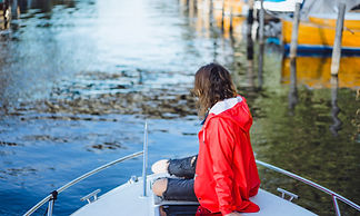 beautiful-young-woman-red-raincoat-rides-private-yacht-stockholm-sweden.jpg