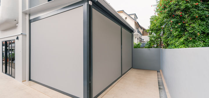 An outdoor space fully concealed by zip track blinds
