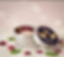 Open silver container with rose petals, GreenDxd logo, and blurred pink background