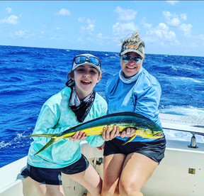 The next generation of female anglers showing off her pretty mahi with Capt. Deb