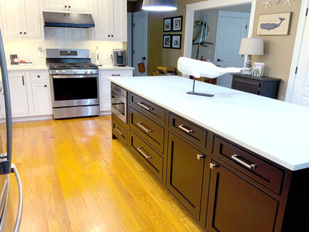 Beautiful kitchen design featuring Island focal point: Emerstone Nebula, polished. Design by Ogunquit Home Design Showroom.