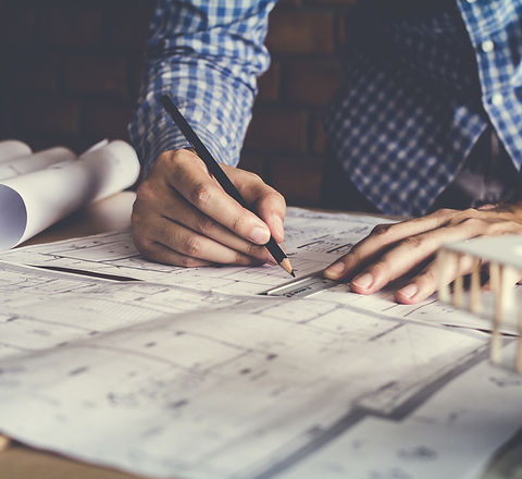 Concept architects, engineer holding pen pointing equipment architects On the desk with a