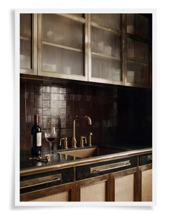 interior design trends of Mixed Materials & Highly Textural Surfaces. close up shot of a luxury kitchen with mixed materials including metal upper cabinets with fluted glass inserts and metal framed lower cabinets with rattan inserts plus luxury hardware and faucet
