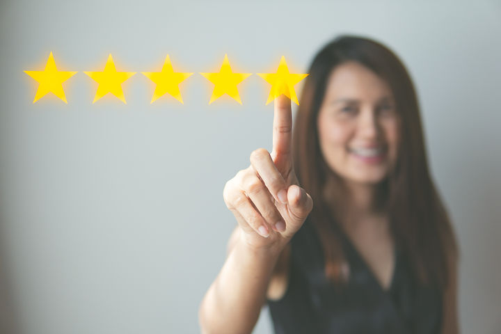 Customer review good rating concept hand pressing five star on visual screen and positive