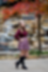fall senior picture in Gahanna by waterfall and red tree and girl in skirt and boots