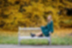Olentangy Orange senior pictures Fall color senior photography senior on bench with yellow leaves