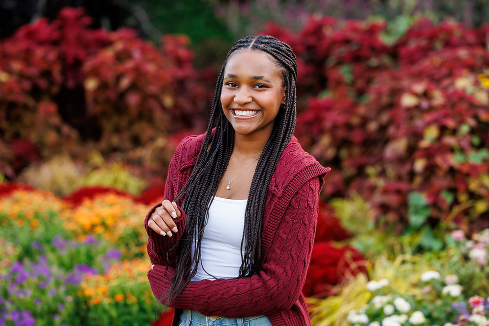 senior picture near Lewis Center Ohio in a park with a vibrant fall background of flowers and trees