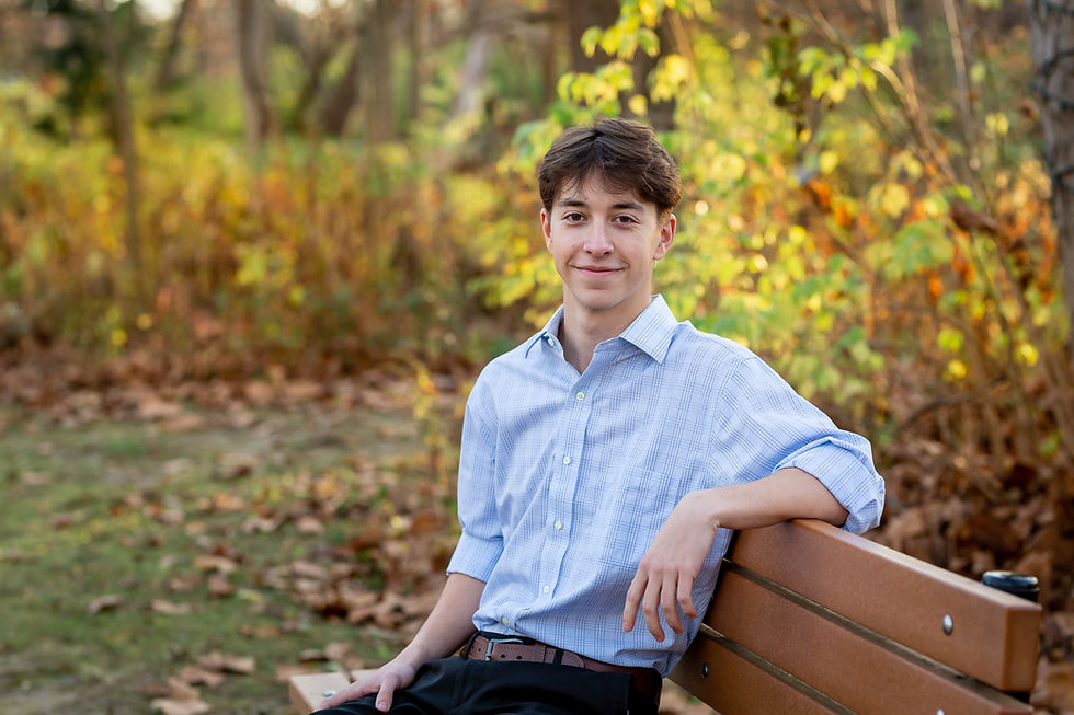 Fall senior pictures for Thomas Worthington senior on bench in park