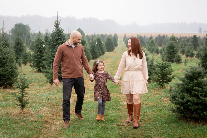 Candid family pictures at tree farm near me for holiday card photos in Columbus.
