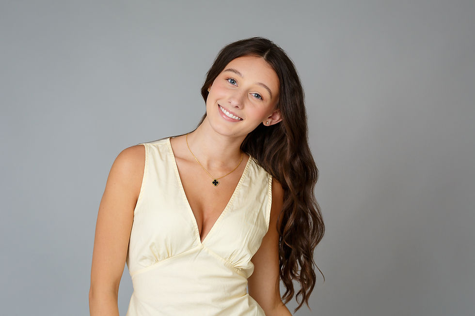 indoor senior picture in Westerville of high school senior girl in front of grey backdrop