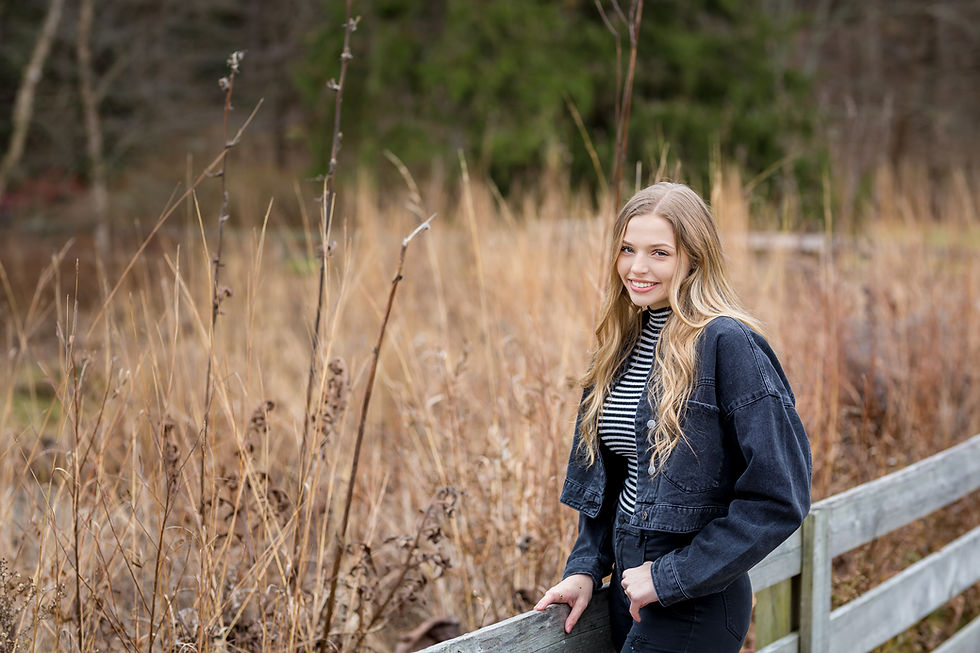 Winter senior picture at Inniswood of girl wearing black denim jacket by field
