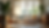 Eye-level view of a cozy living room with natural light and plants