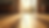 Eye-level view of natural wood flooring with warm sunlight