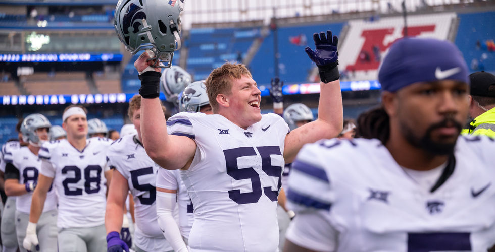 K-State offensive lineman, Kyle Rakers with his hands in the air celebrating after beating KU.