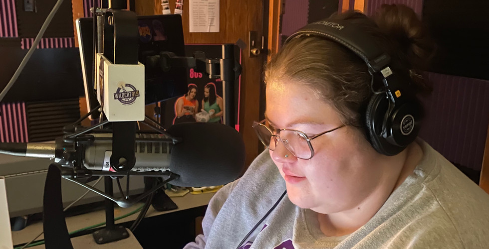 Anna sits in front of the microphone in studio D at Wildcat 91.9