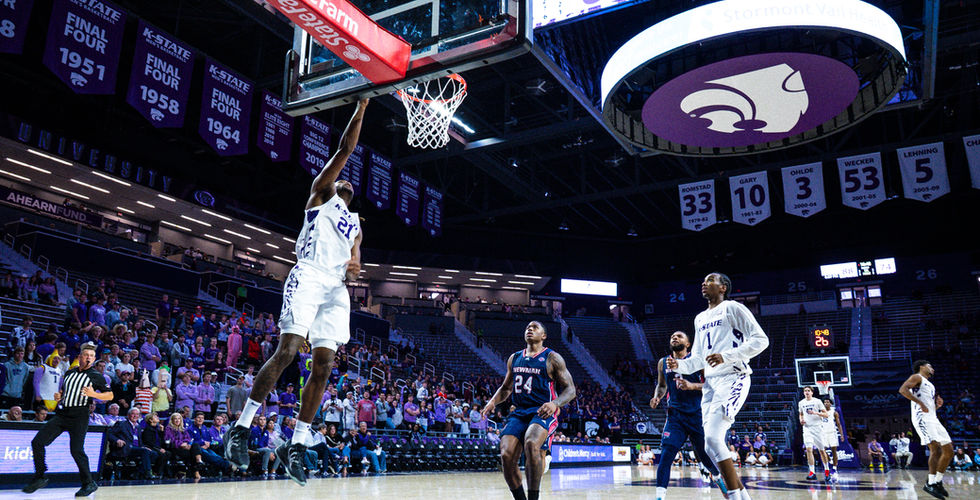A K-State men's basketball player lays the ball into the hoop. Courtesy: Sam Lowther