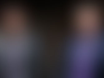 Christian Peña and Caden Bastian sit on stage next to each other.