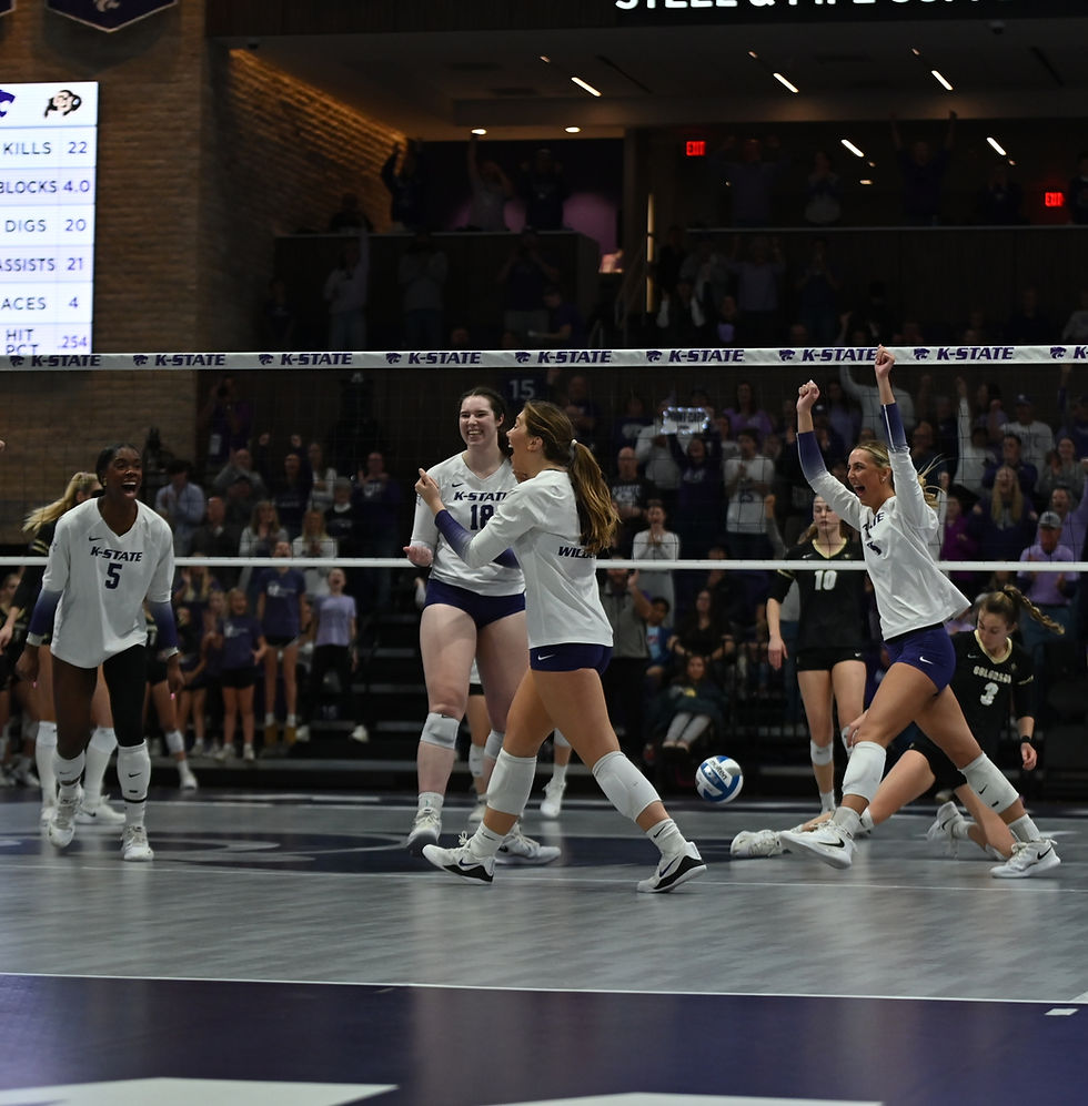 K-State volleyball players celebrate after winning a set against Colorado.