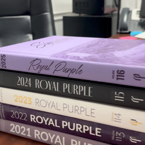 A stack of Royal Purple Yearbooks.